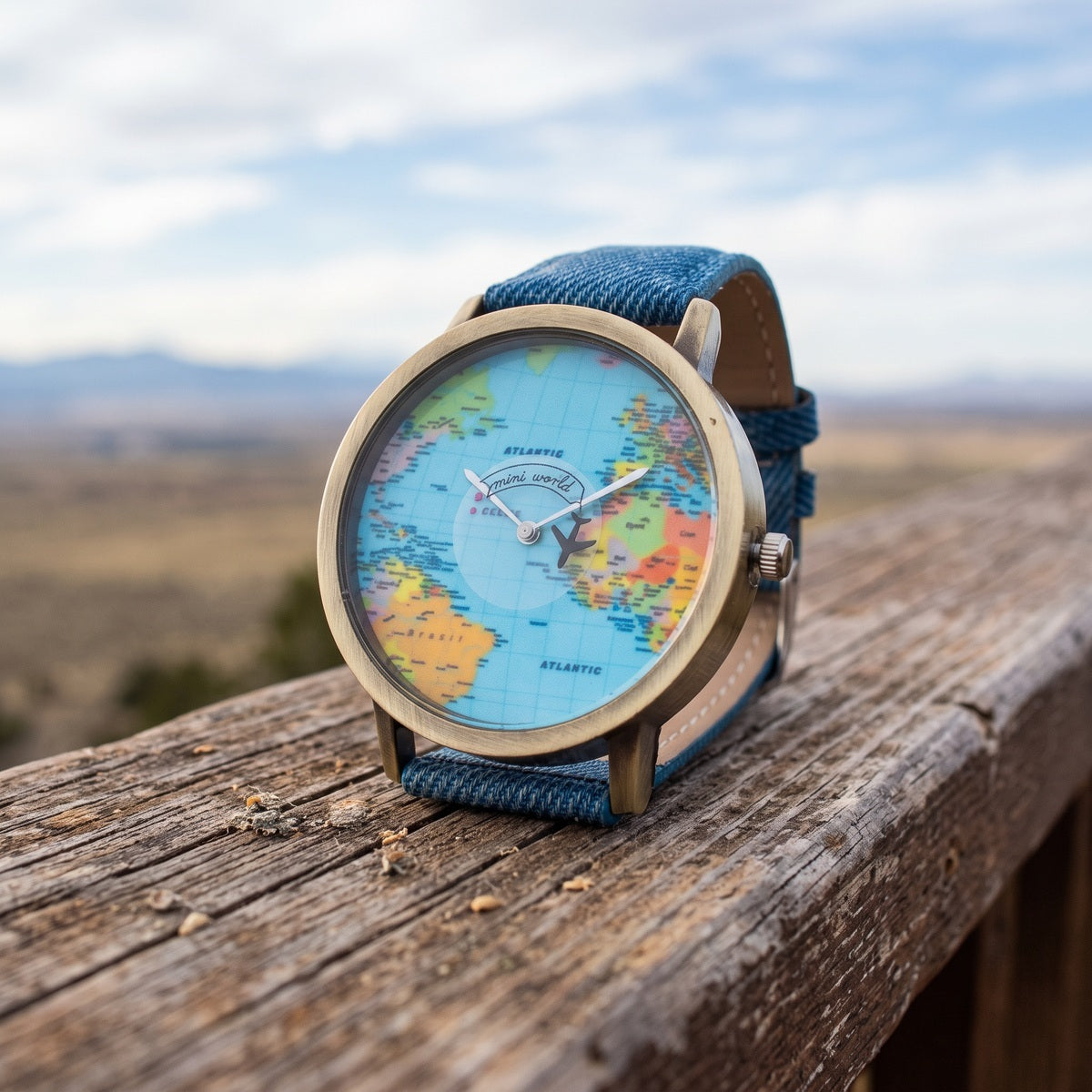 Blue Skybound watch close-up showing the map, silver hands and tiny black plane