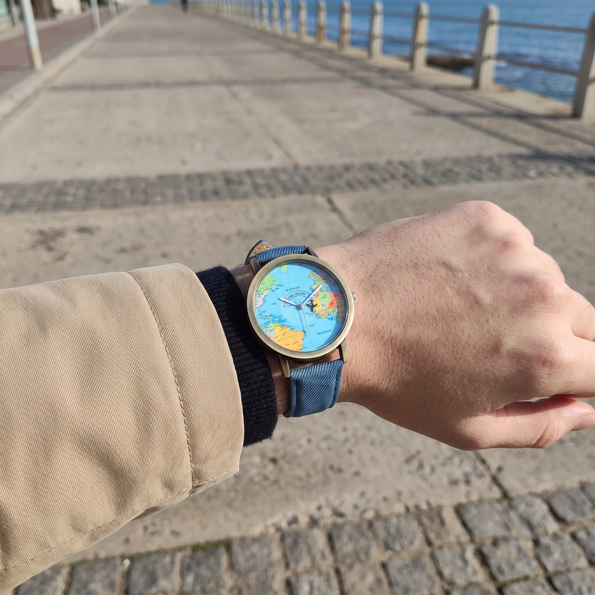 Blue Skybound watch worn on a coastal promenade