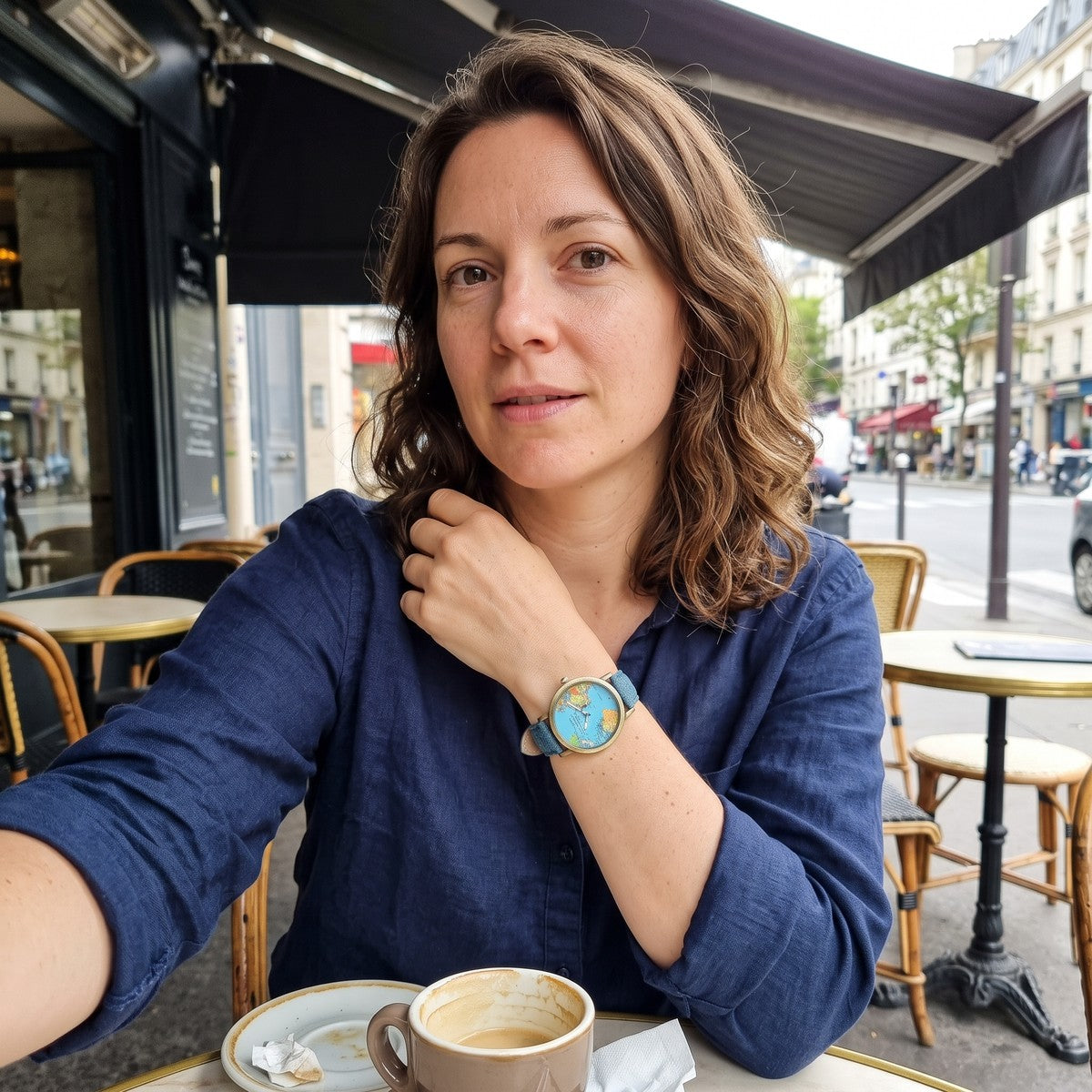 Woman at a cafe wearing a Blue Skybound watch